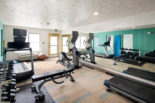 a gym with several treadmills and exercise machines at Holiday Inn Express Hotel & Suites Coeur D'Alene I-90 Exit 11 by IHG in Coeur d'Alene