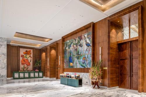 a lobby with a large painting on the wall at Taj Mussoorie Foothills, Dehradun in Dehradun