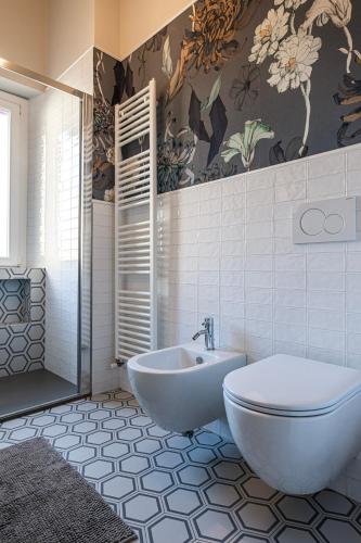 a bathroom with a tub and a toilet and a sink at LaMalatestina Suite - Apartment in front of the Castle in Rimini