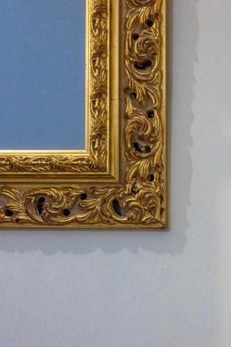 a gold picture frame hanging on a wall at LaMalatestina Suite - Apartment in front of the Castle in Rimini