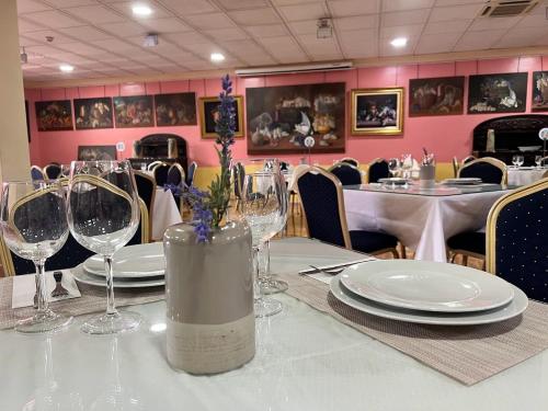 a dining room with a table with wine glasses at Hotel Pinomar in El Puerto de Santa María
