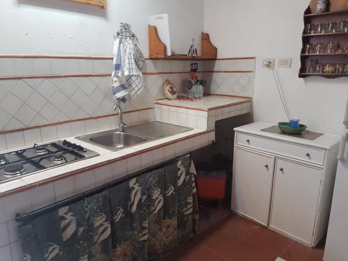 a small kitchen with a sink and a stove at Iddu & Idda in Stromboli