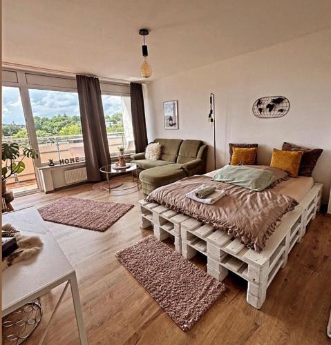 a living room with a bed and a couch at Apartment mit schönem Ausblick in Lüdenscheid
