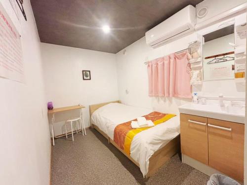 Postel nebo postele na pokoji v ubytování Hananosato Hotel 池袋本店