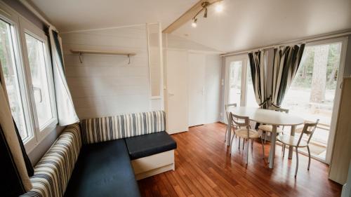 a living room with a table and a couch at Camping Cobijo in Vinuesa