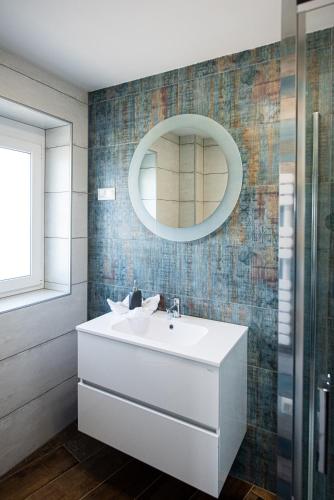 a bathroom with a sink and a mirror at Aranyszarvas Panzió****, Étterem és Grillterasz in Szarvas