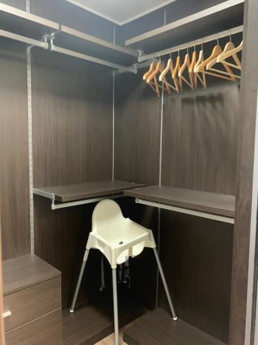 a walk in closet with a stool and a chair at Ulsan Shimpo KCC Residence in Ulsan