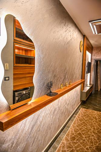a kitchen with a wall with a wooden shelf at Luxury Poolside Retreat Elegant Apartment two rooms within a Seafront Hotel in Sharm El Sheikh