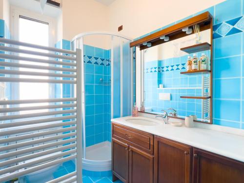 a blue bathroom with a sink and a shower at Rifugio Al Mare in Genova