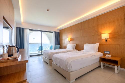 Katil atau katil-katil dalam bilik di INFINITY BY YELKEN AQUAPARK&RESORTS KUŞADASI
