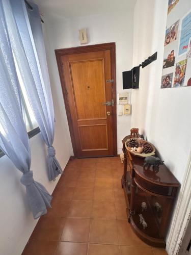 a hallway with a door and a table and a floor at Wbs in Almería