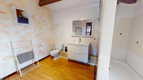 a bathroom with a toilet and a sink at le clos des dryades f in Vers