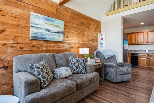 a living room with a couch and two chairs at Lakelife at Somerset home in Somerset