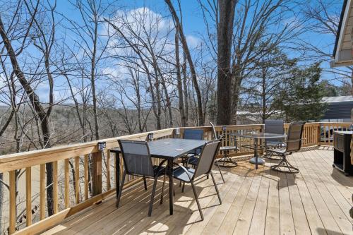 a deck with a table and chairs on it at Lakelife at Somerset home in Somerset