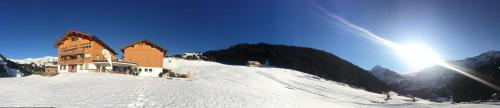 a building on top of a snow covered mountain at dr'Berghof in Damuls