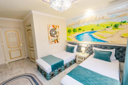 two beds in a room with a painting on the wall at Gur Emir Palace boutique hotel in Samarkand