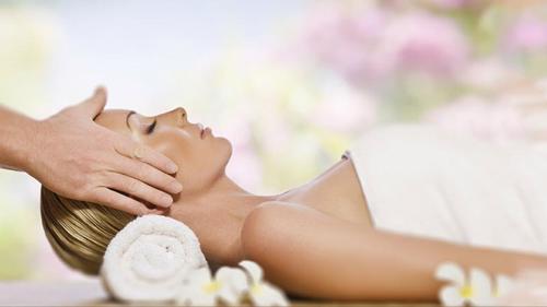 a woman getting a massage from a therapist at Waterlily Hotel Apartments in Kalathas