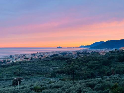 a view of a city at sunset at Villa Laura in Pietra Ligure