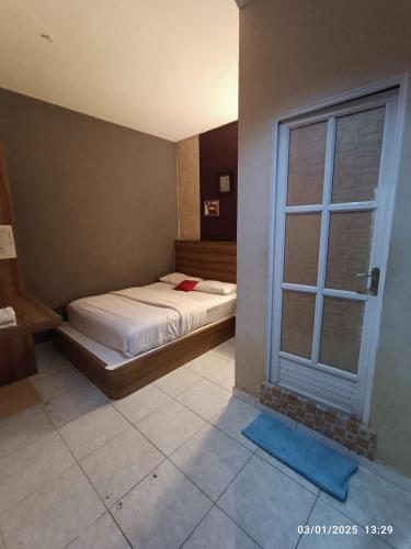 Postel nebo postele na pokoji v ubytování N Hotel Syariah