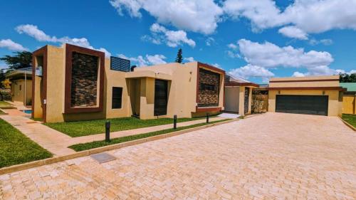 a large house with a driveway in front of it at Hilltop Executive Lodge in Lilongwe