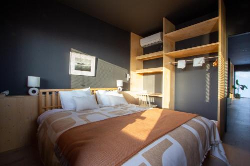 a bedroom with a large bed with white pillows at Wave Villa with Ocean Views in Onjuku