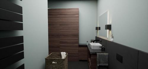 a bathroom with a sink and a mirror at Allgäuer Bergwald Chalets in Oberstaufen