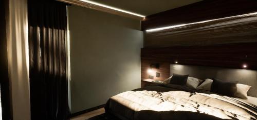 a bedroom with a large bed and a window at Allgäuer Bergwald Chalets in Oberstaufen