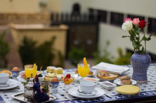 a table with breakfast foods and drinks on it at Riad Dar Bab Guissa in Fès