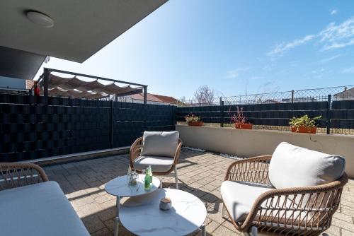 a patio with two chairs and a table at Argola in Trogir