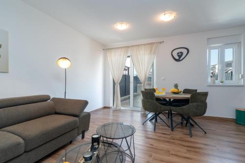 a living room with a couch and a table at Argola in Trogir