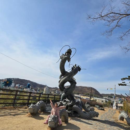 a statue of a dragon sitting on some animals at Best value, Fresh Air Village in Pohang