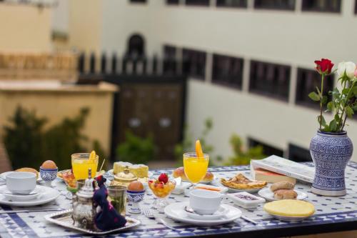 a blue and white table with food and drinks on it at Riad Dar Bab Guissa in Fès