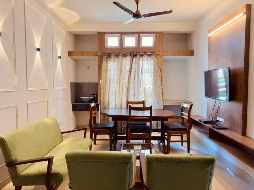 a living room with a table and chairs at NE Residency in Guwahati