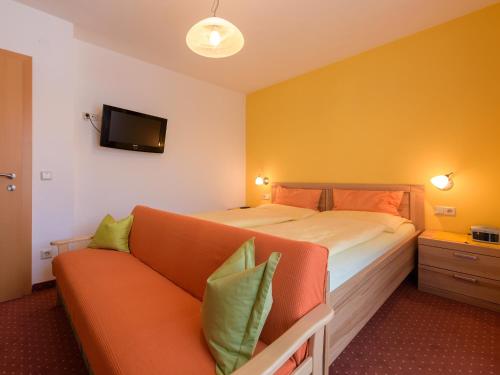 a hotel room with a bed and a couch at Haus Maier in Flachau