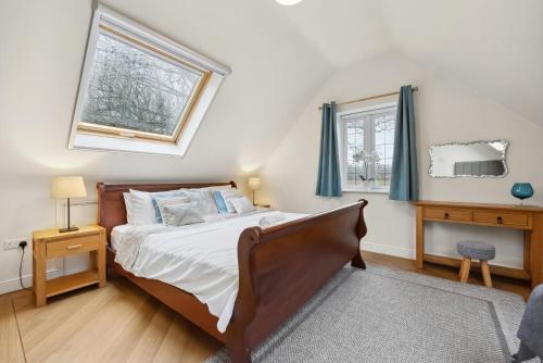 a bedroom with a bed and a window at Beautiful Country Apartment, rated Exceptional in Coventry