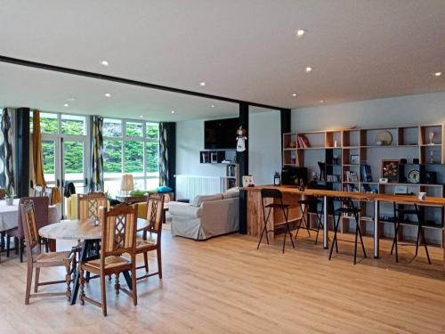 un salon et une salle à manger avec une table et des chaises dans l'établissement Natural green group villa classified 4 ears, à Penmarcʼh