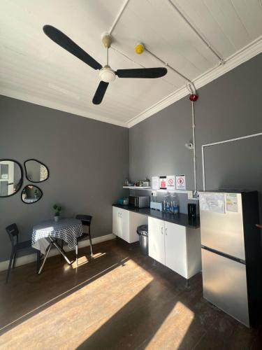a kitchen with a ceiling fan and a table at CapePod Sea Point in Cape Town