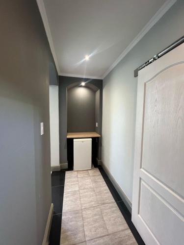 a hallway with a door and a counter in a room at CapePod City Centre in Cape Town