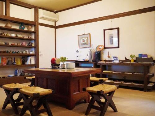 a kitchen with a large wooden table and chairs at Wakaki Ryokan - Nasu Yumoto Onsen in Nasu