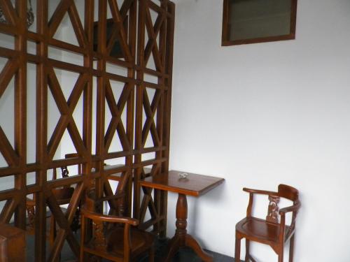 a wooden stairway with a table and a chair at Bladok Hotel & Restaurant in Yogyakarta