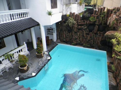 an overhead view of a swimming pool in a building at Bladok Hotel & Restaurant in Yogyakarta