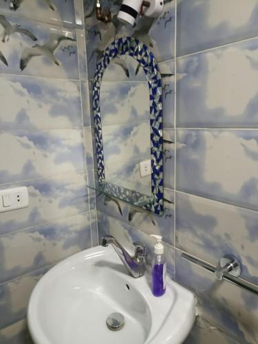 a bathroom with a sink and a mirror at Chillax Dahab in Dahab