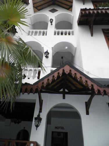 a white building with a sign that reads hotel at Bladok Hotel & Restaurant in Yogyakarta