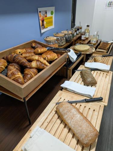 a bakery with a bunch of loaves of bread at Appart Hotel Odalys City Toulouse Colombélie in Toulouse