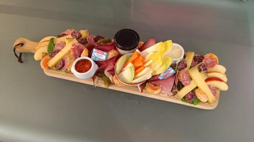 a tray of different types of food on a table at La roulotte tiny house du Mond'idéal in Leval