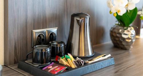 a tray with a coffee pot on a table at PLAZA Hotel Buchhorner Hof in Friedrichshafen