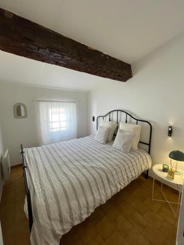 une chambre avec un grand lit avec des draps blancs dans l'établissement Escapade confort Toulon, à Toulon