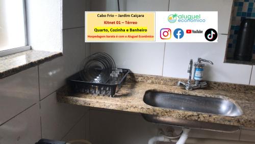 a sink in a bathroom with a sign above it at Cabo Frio - Jardim Caiçara - Aluguel Econômico in Cabo Frio