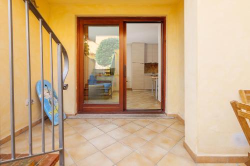 a room with a door with a view of a living room at Residence Orizzonti app n 3 in Golfo Aranci