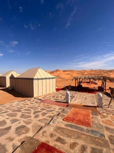 a building in the middle of the desert at Riad Moha in Merzouga